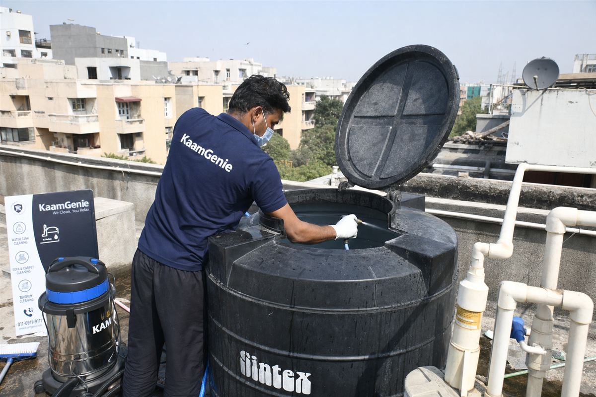 KaamGenie crew cleaning a Sintex / plastic tank in Vasant Kunj, Delhi