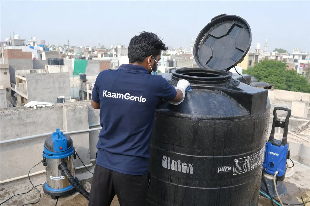 KaamGenie crew cleaning a Sintex / plastic tank in Zakir Nagar, Delhi