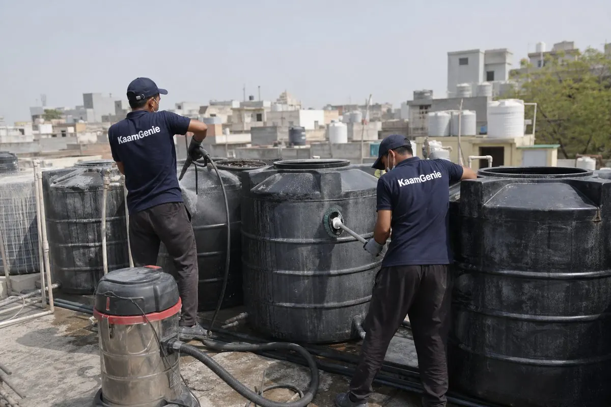 KaamGenie crew cleaning a society water tank in Adchini, Delhi