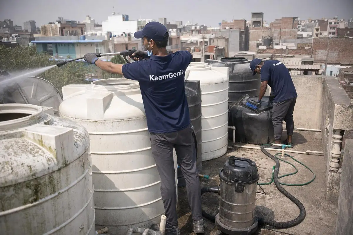 KaamGenie crew cleaning a society water tank in Aya Nagar, Delhi