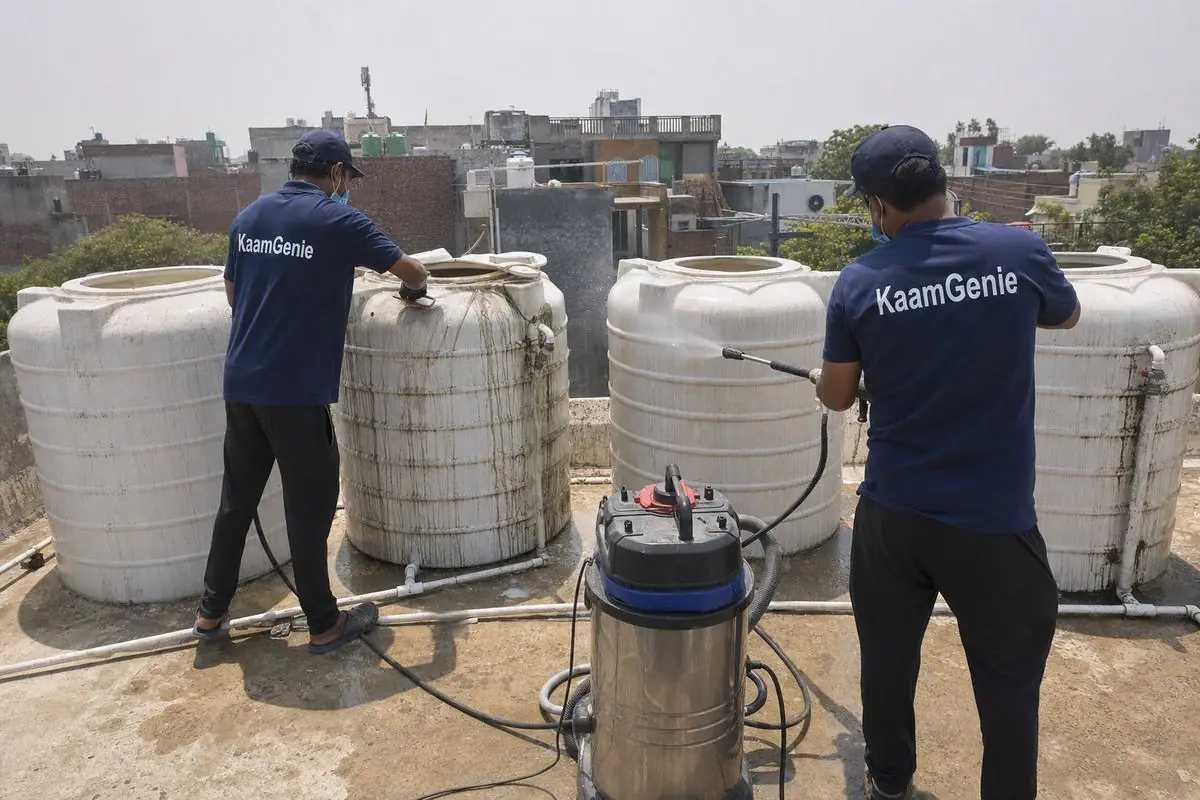 KaamGenie crew cleaning a society water tank in Bhati, Delhi
