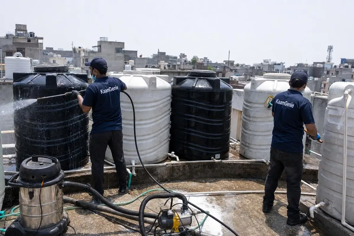 KaamGenie crew cleaning a society water tank in Deoli, Delhi