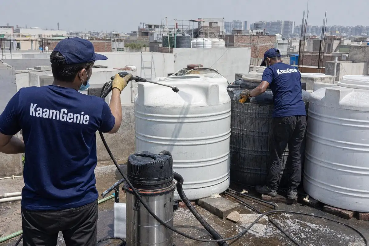 KaamGenie crew cleaning a society water tank in Dwarka Mor, Delhi