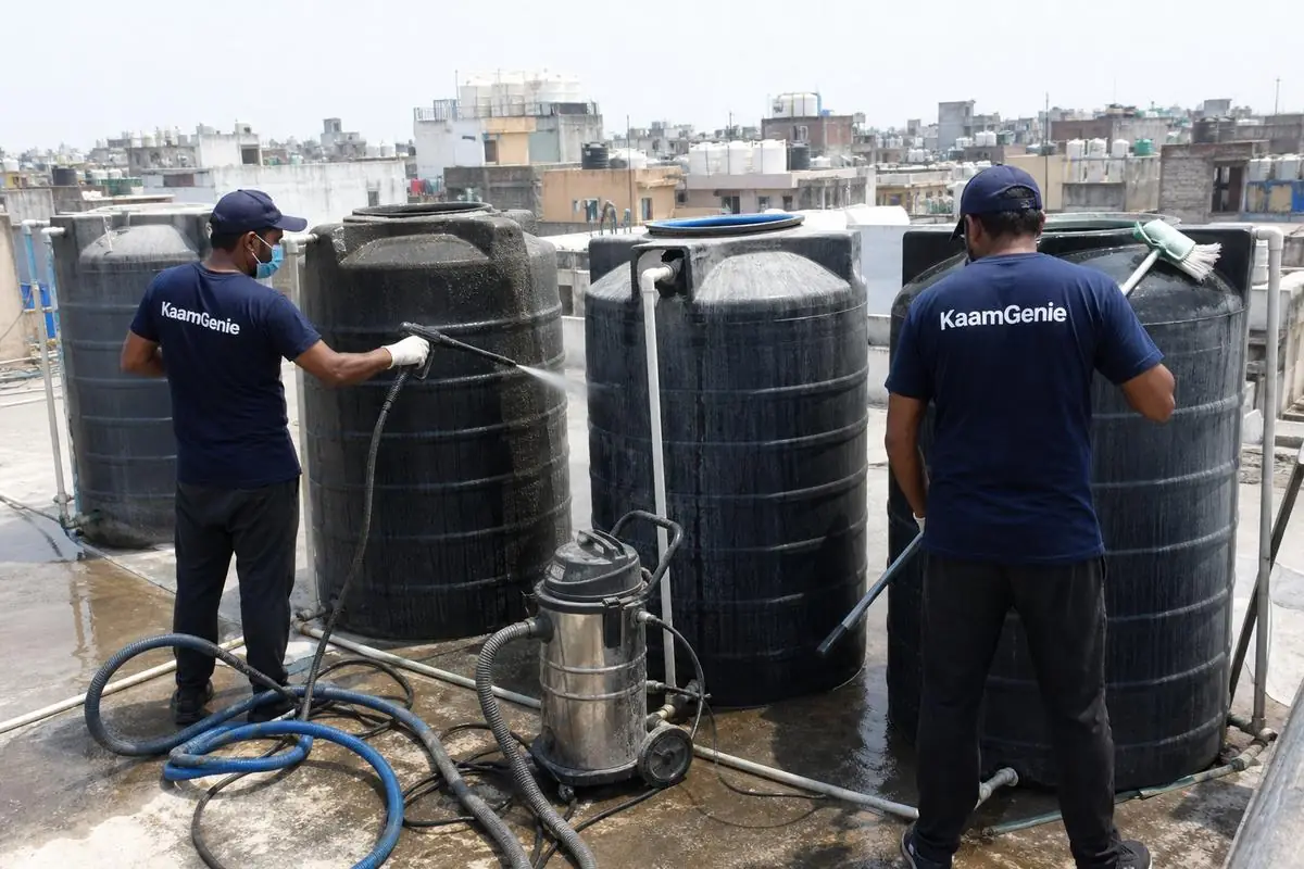 KaamGenie crew cleaning a society water tank in Gandhi Nagar Bazar, Delhi