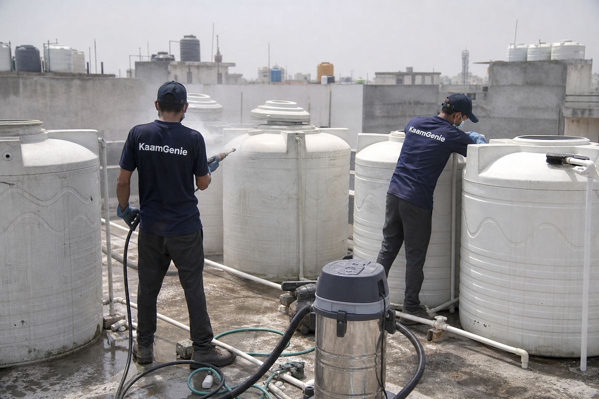 KaamGenie crew cleaning a society water tank in Jal Vihar, Delhi