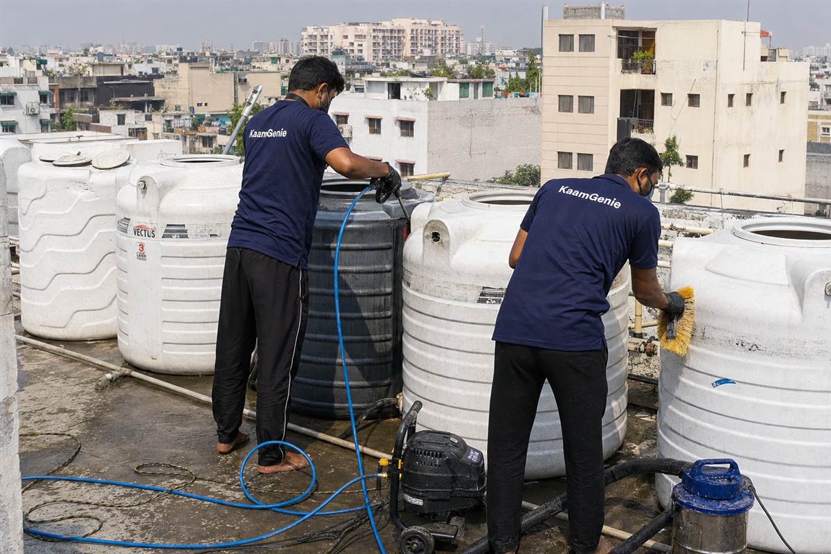 KaamGenie crew cleaning a society water tank in Kalkaji, Delhi