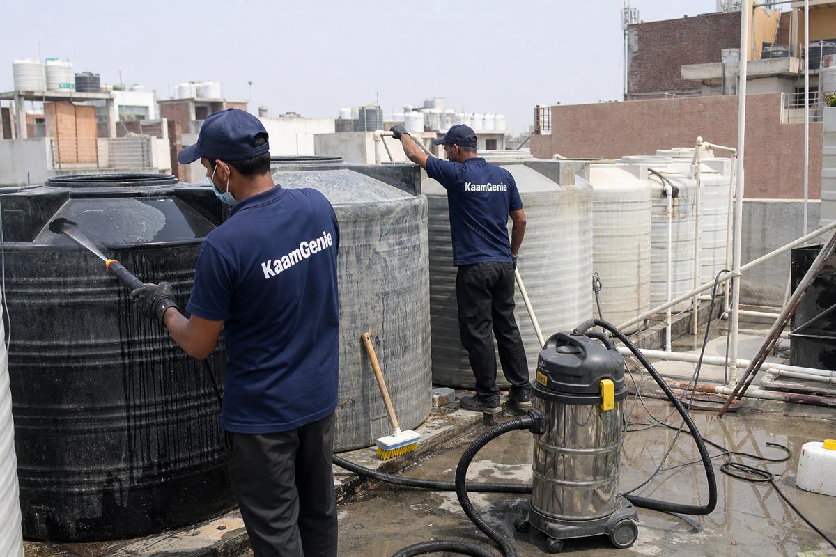 KaamGenie crew cleaning a society water tank in Karam Pura, Delhi