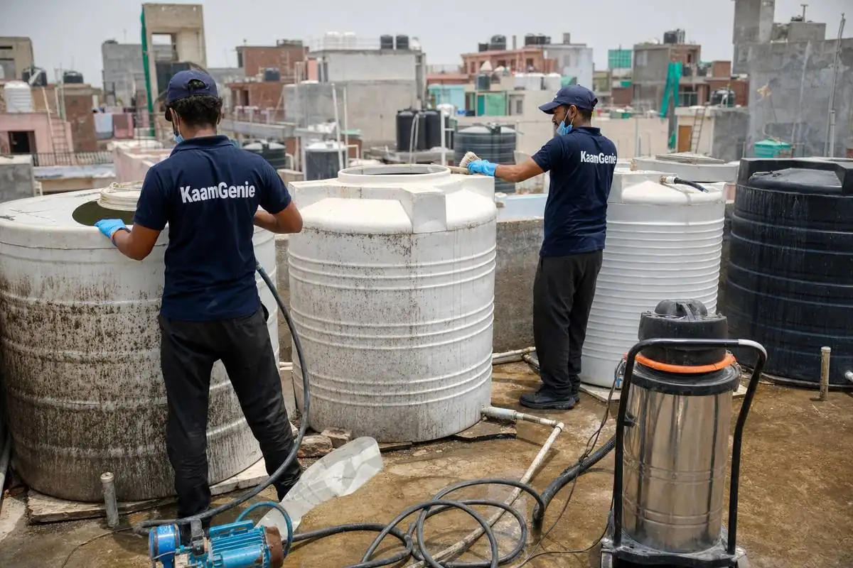 KaamGenie crew cleaning a society water tank in Khirki Village, Delhi
