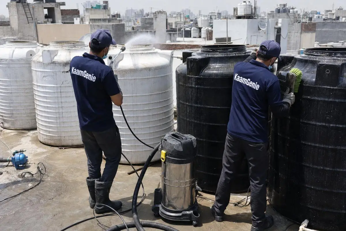 KaamGenie crew cleaning a society water tank in Lado Sarai, Delhi
