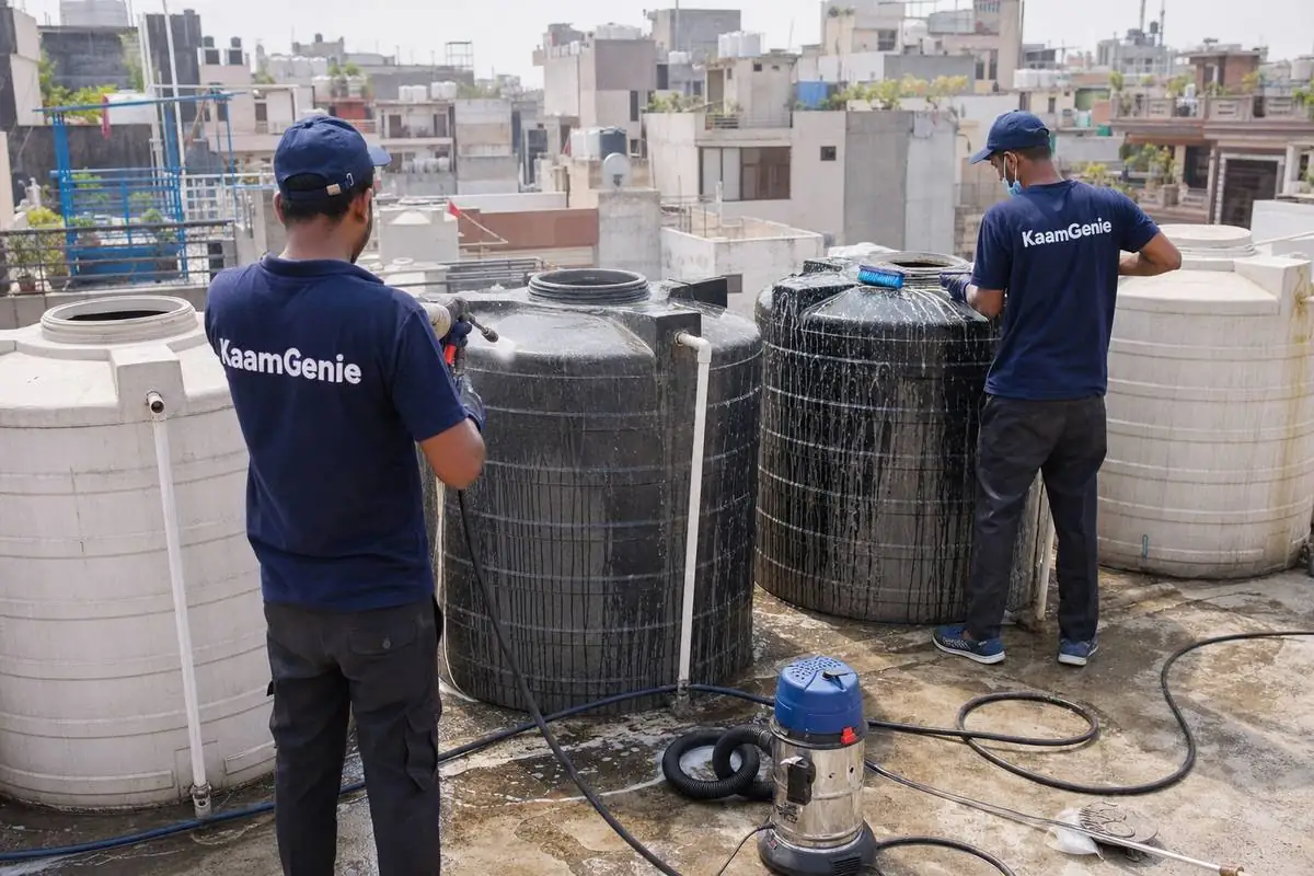 KaamGenie crew cleaning a society water tank in Masudpur, Delhi