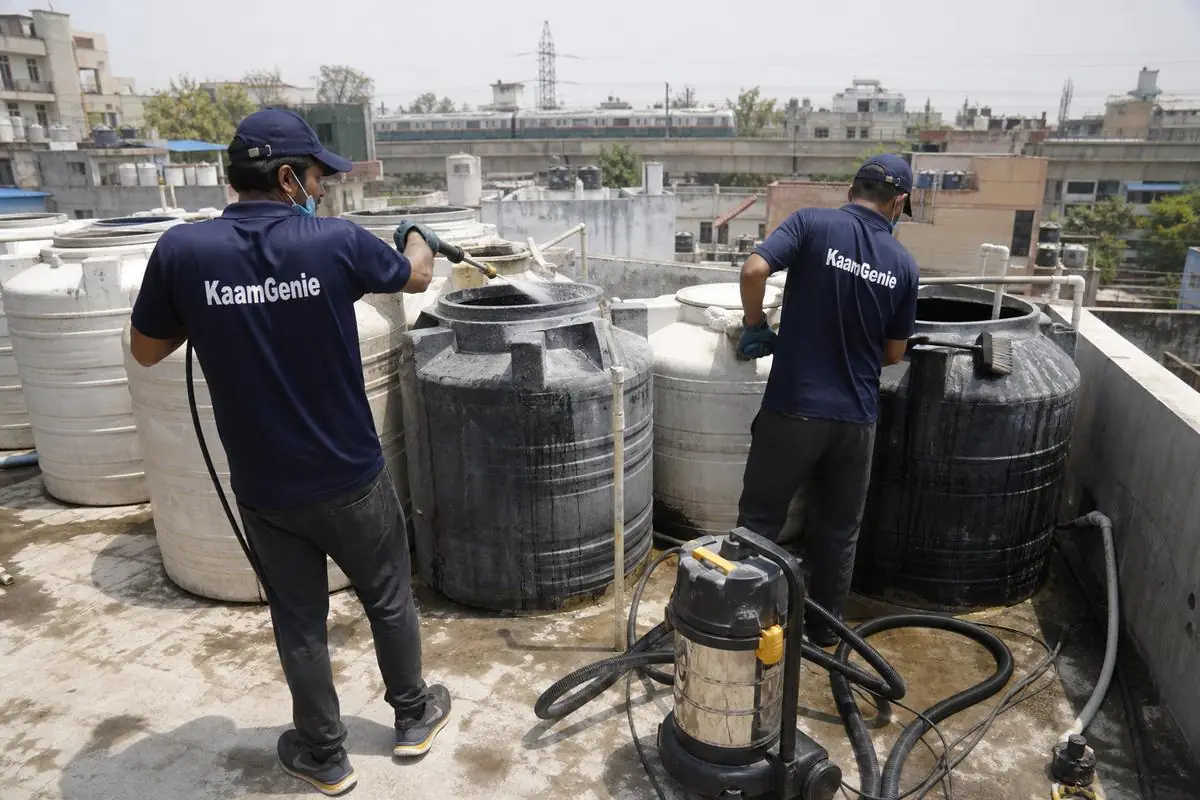 KaamGenie crew cleaning a society water tank in Maujpur, Delhi