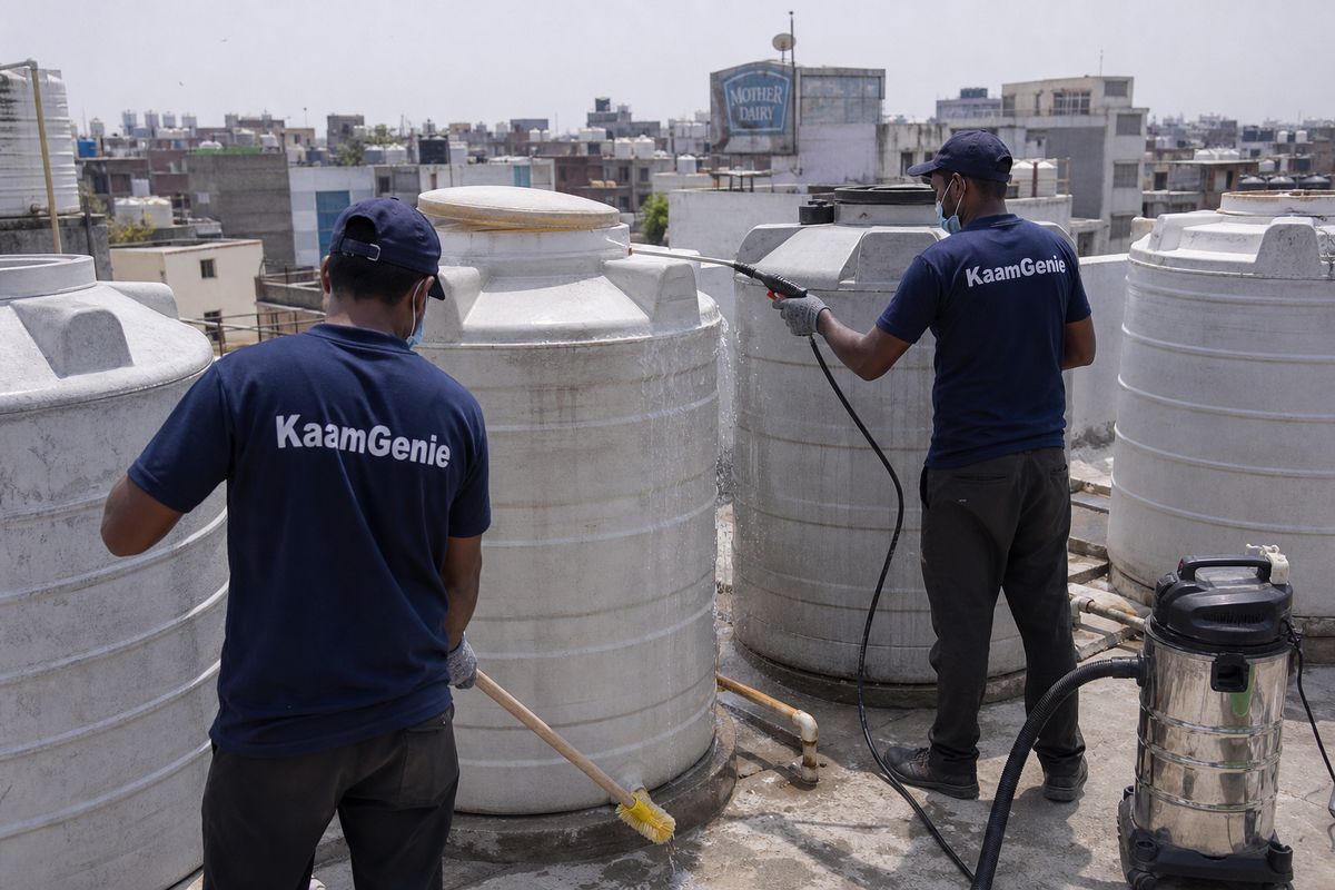 KaamGenie crew cleaning a society water tank in Pandav Nagar, Delhi