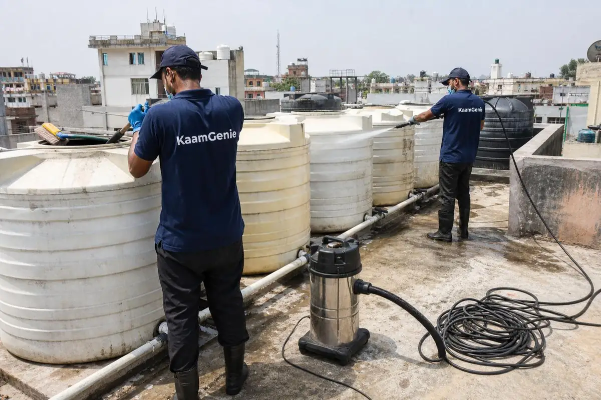 KaamGenie crew cleaning a society water tank in Roop Nagar, Delhi
