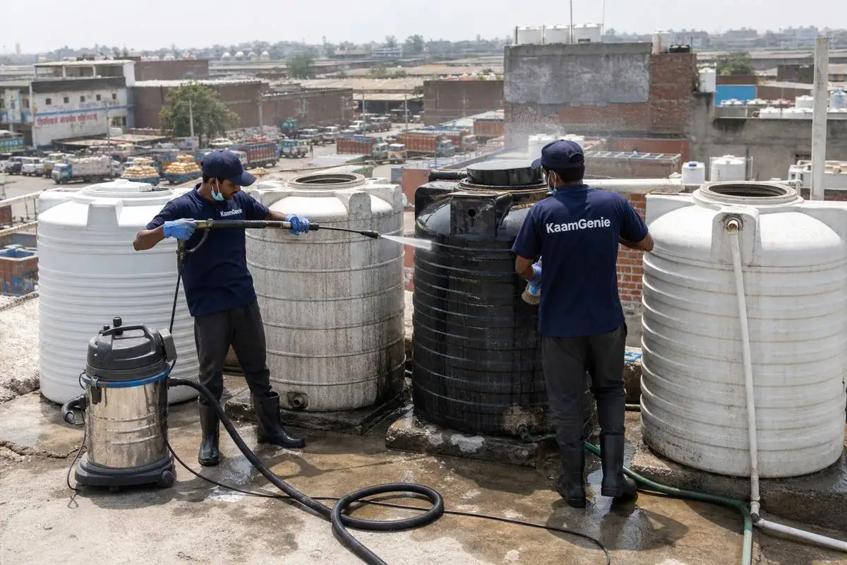 KaamGenie crew cleaning a society water tank in Tikri Kalan, Delhi