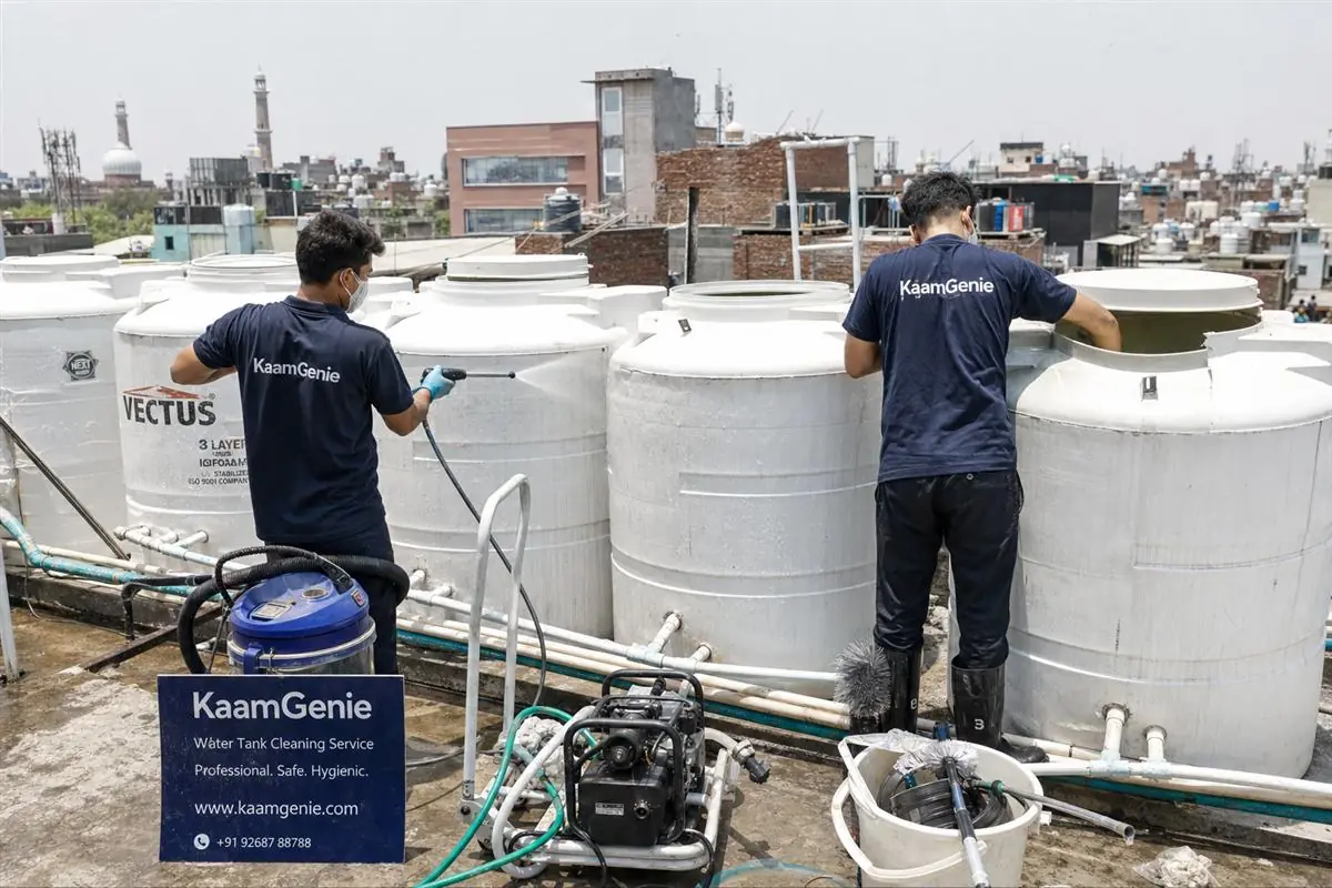 KaamGenie crew cleaning a society water tank in Zakir Nagar, Delhi