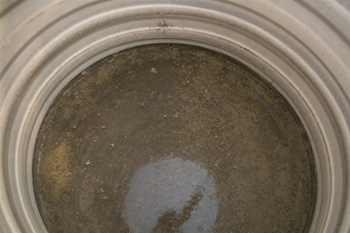 Close-up of dirty sediment, sludge and biofilm inside a storage water tank that feeds a Delhi home