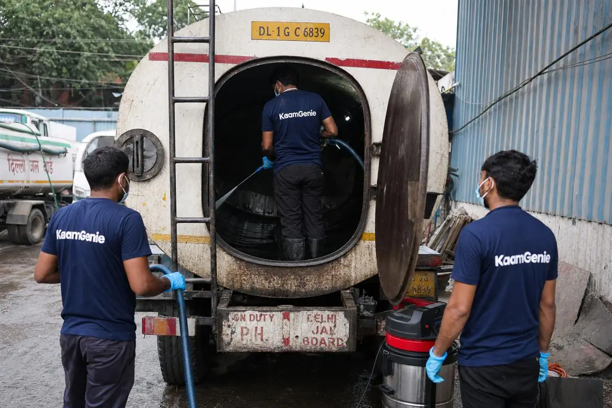 KaamGenie crew sanitising the interior of a water-supply tanker truck at a Delhi depot