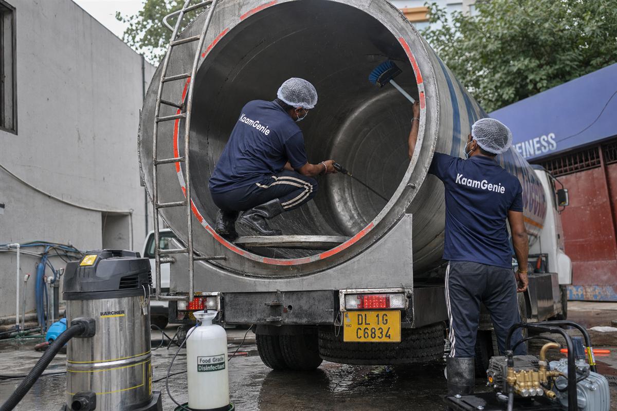 KaamGenie crew sanitising the interior of a water-supply tanker truck at a Delhi depot