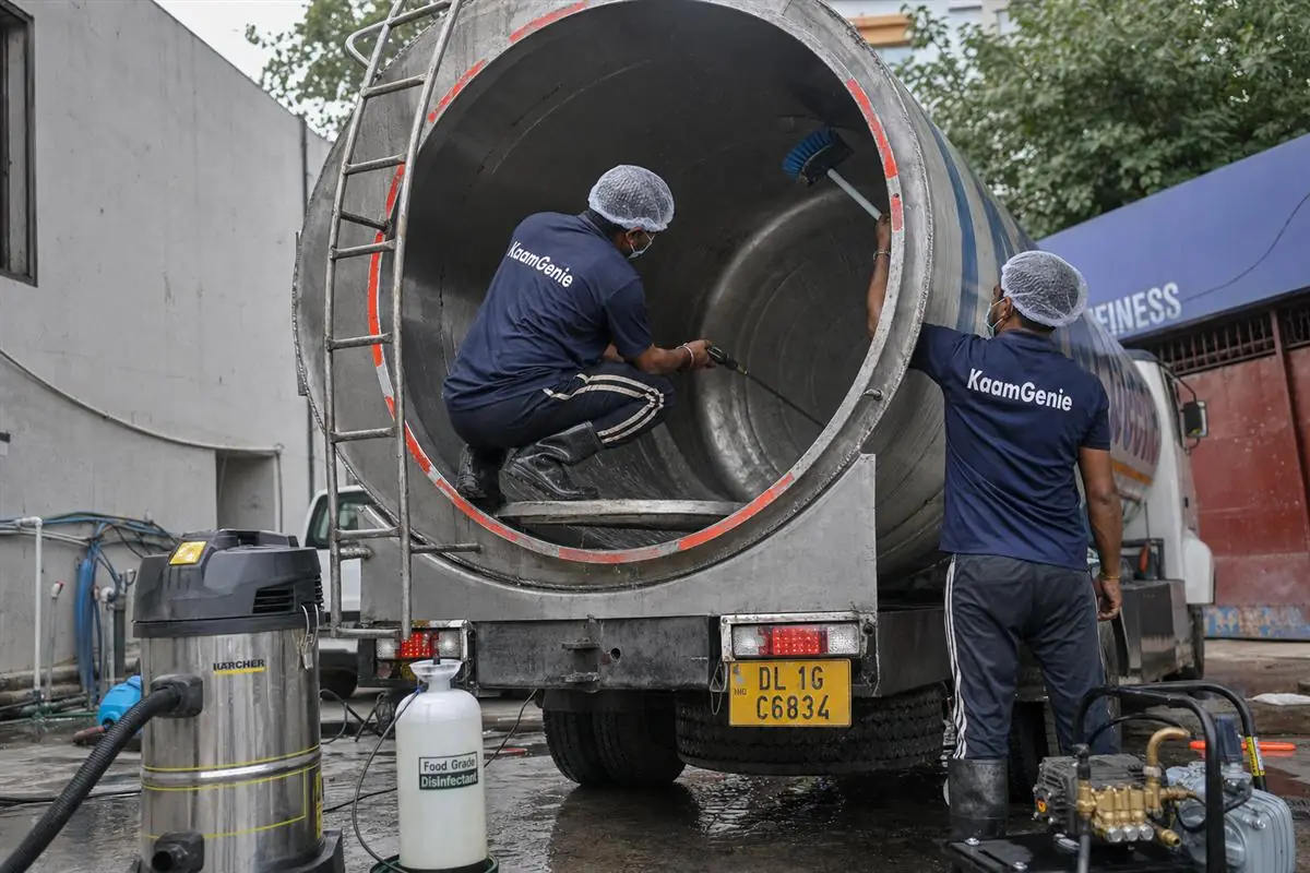 KaamGenie crew sanitising the interior of a water-supply tanker truck at a Delhi depot